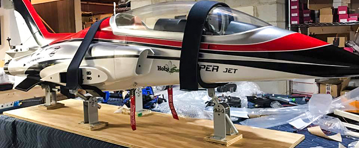 Red RC Viper jet airplane secured (tied down) in workshop (workstand)using Random Heli Gear Jacks Fuselage Support Assemblies